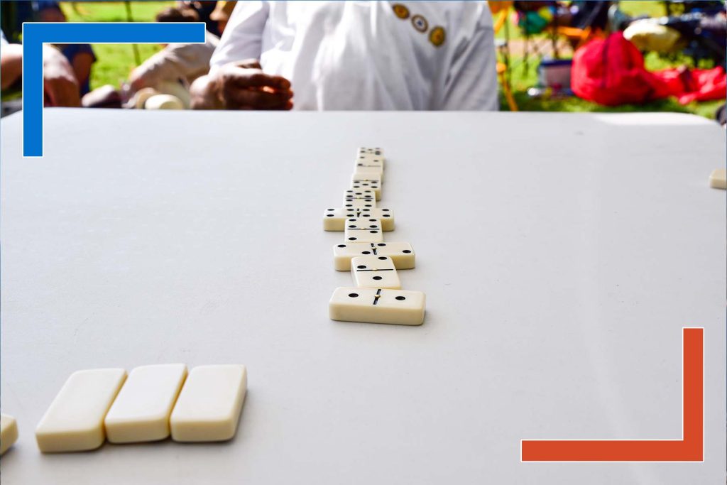 Row of dominoes on a table symbolizing connected data and decision chains enabled by Tableau developers for executive insights.